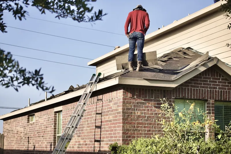 Professional roofer working on a residential roof in Frankfort Square
